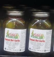 THE FONT AHSLI'S IS CURSIVE PICKLES BOLD FONT ASHLI'S IS LOCATED ON TOP OF PICKLES.